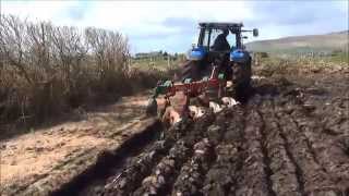New Holland TM 140 ploughing