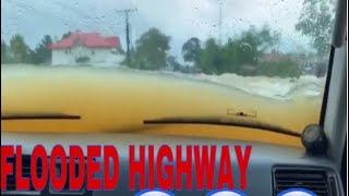 SUV car crossing a flooded highway