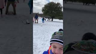 Sophia and grandpa sledding Flagpole Hill 2021