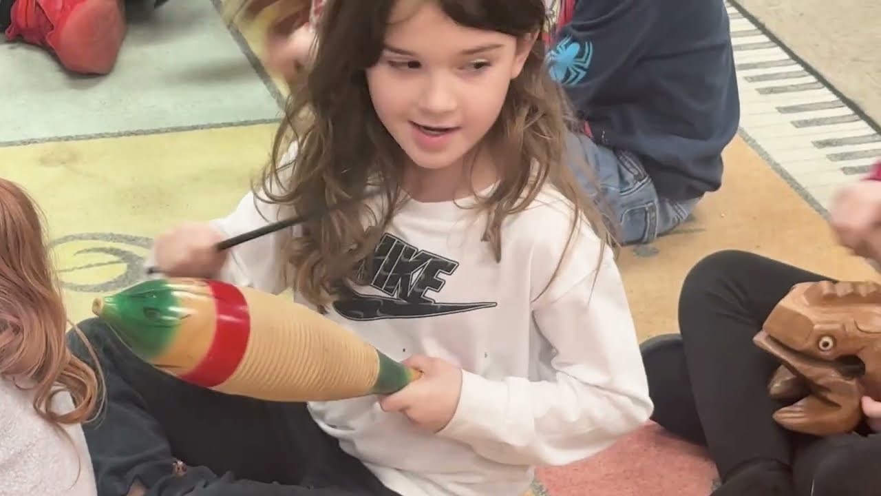 Video preview image of Children play musical instruments in elementary classroom.; click to visit the ParentSquare post with the video