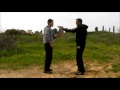 Krav maga technique defending a pistol threat from the front