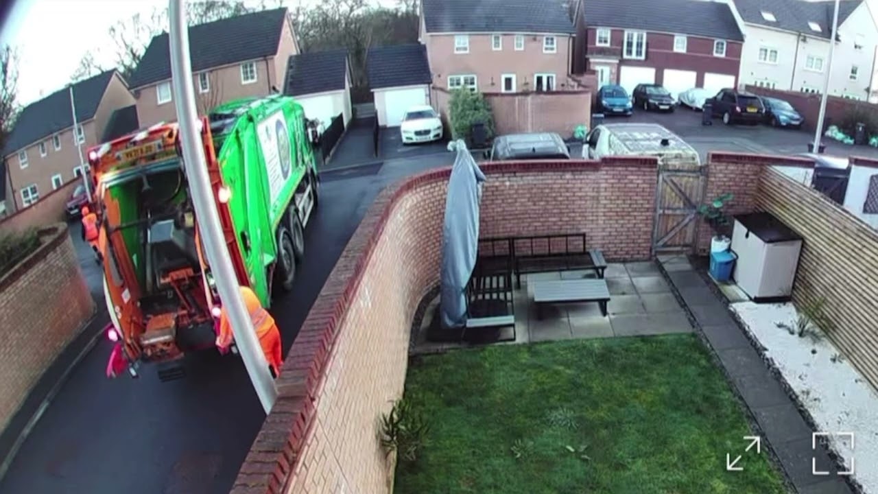Garbage collector throws bin into truck after mishap in Cardiff, Wales, UK