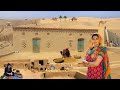 Traditional desert village life in pakistan  desert woman building cultural mud house  old culture
