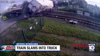 Train crashes through truck on tracks, spilling cargo and debris everywhere