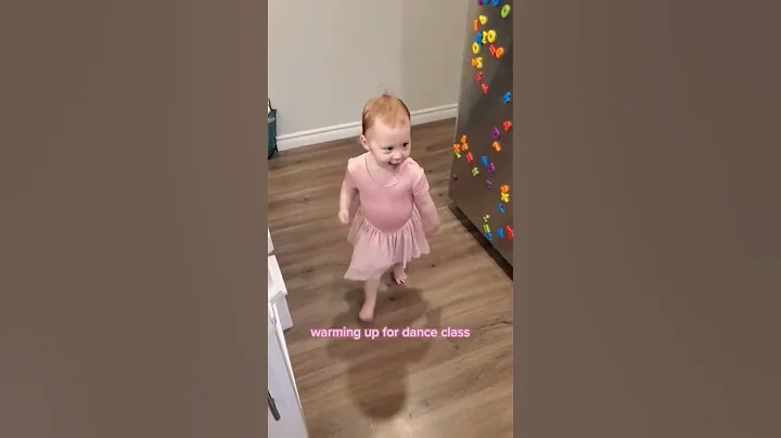 Warming up for toddler dance class with two of her...