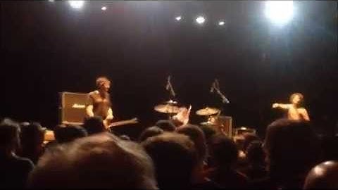 Bob Weston explains the function of a guitar strap, and declines a beer