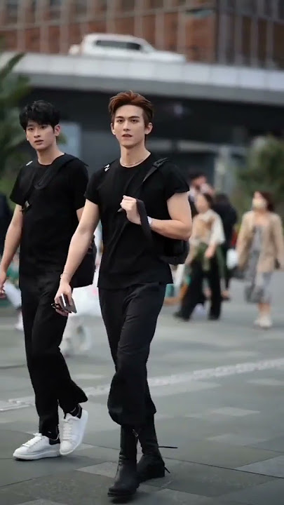 Korean street fashion wear men.Cute Boys walking in the street.