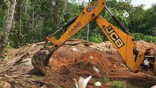 jcb 3dx transporting soil and levelling land