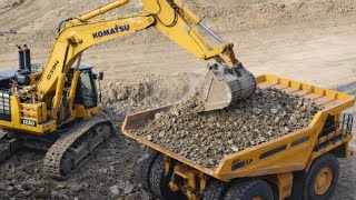 Powerful Komatsu Excavator Loading A Line Of Belaz Dump Trucks