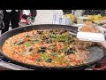 London Street Food. Preparing Seafood Pella and Chicken Paella in Portobello Road