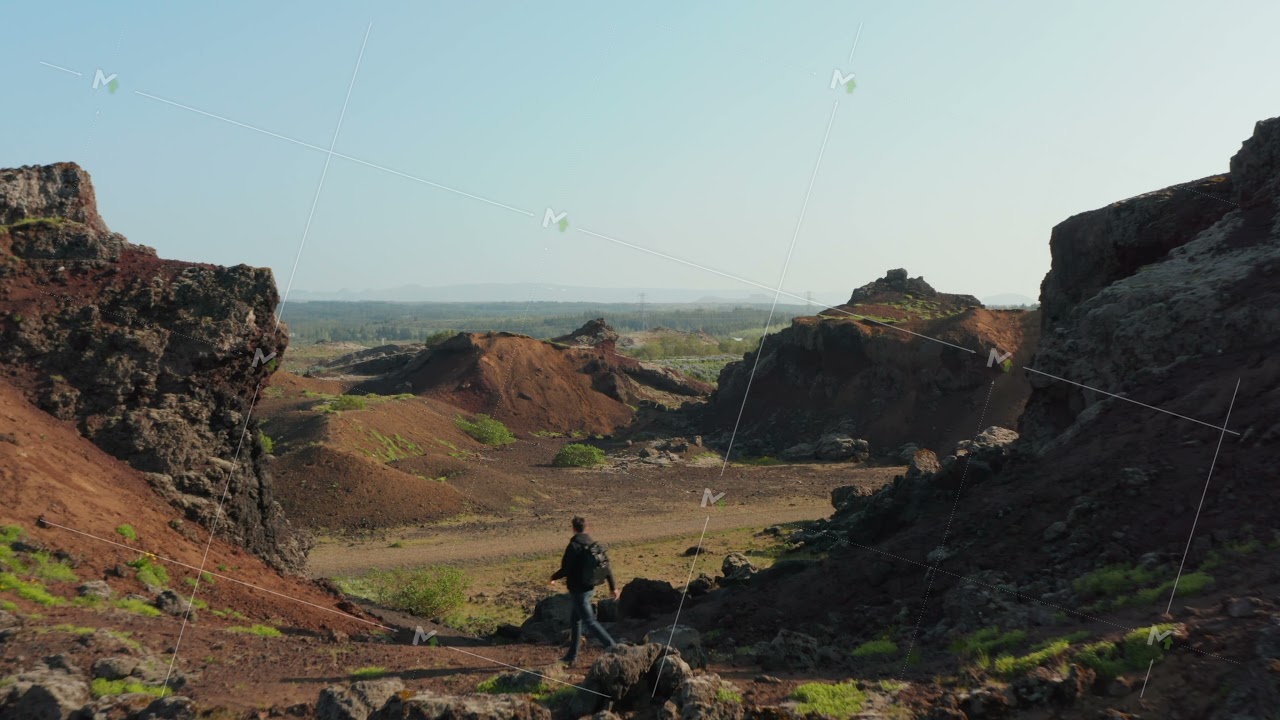 Birds eye drone view man backpacker hiking walkway in desert rock exploring beauty in nature in