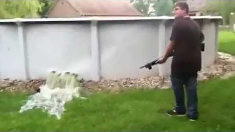 Redneck demostrates how to empty a pool with shotg...