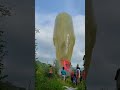 Menerbangkan balon udara 14 meter saat hari ketupat
