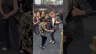 #MichaelMovie star Juliano Valdi busts a move with Derek Hough on the black carpet! 🕺🙌