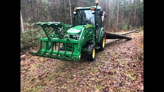 John Deere 3046R Cab tractor with a Fransgard V-3507 forestry winch skidding trees.