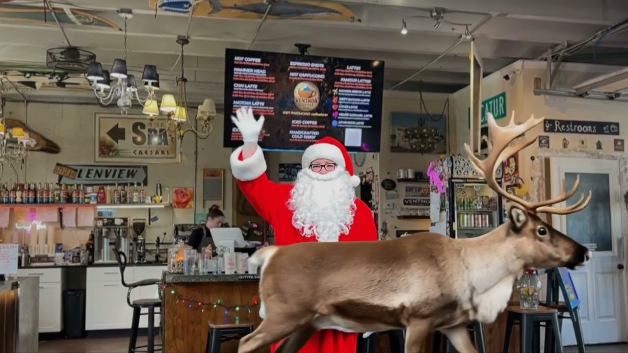 christine in santa suit waving