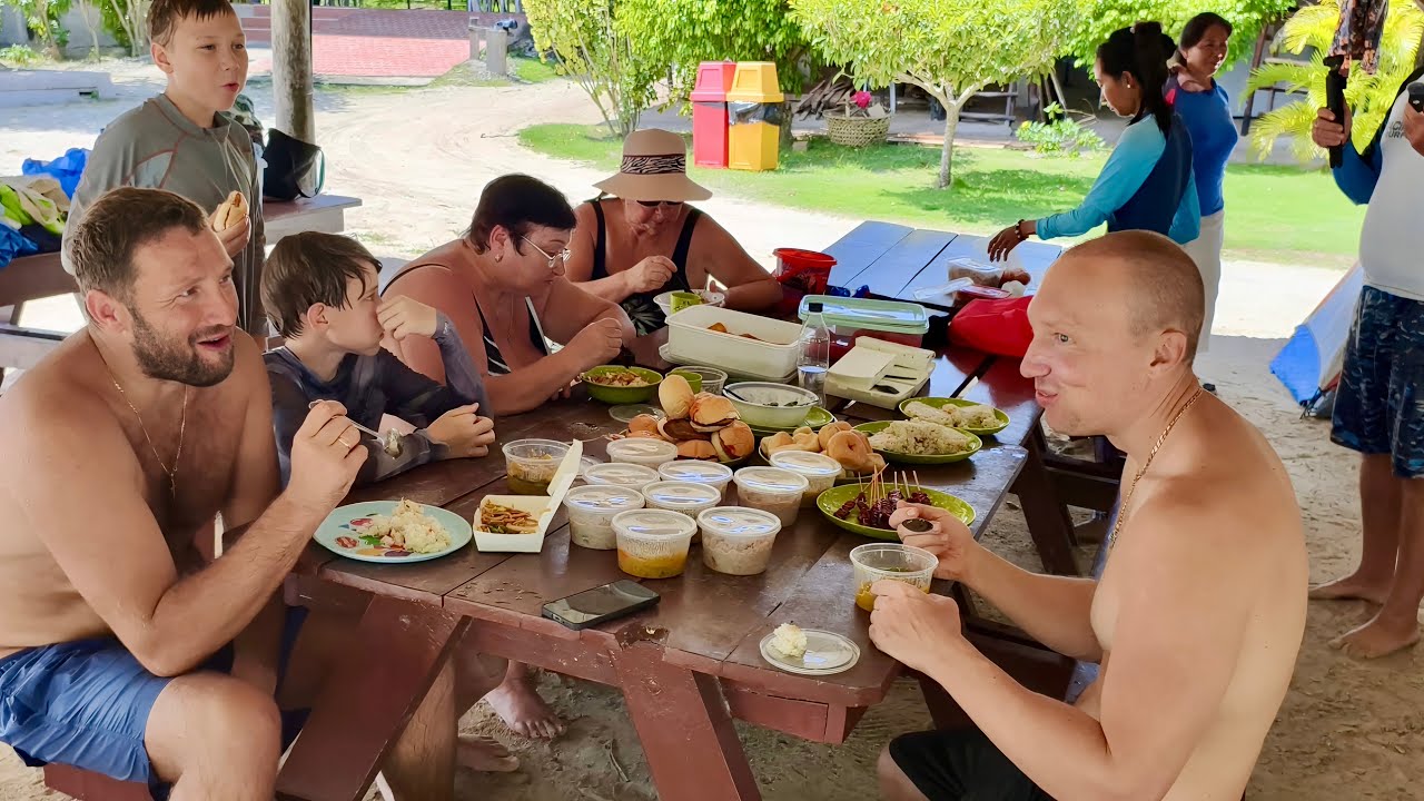 MY FAMILY AND FRIENDS REALLY ENJOYING FILIPINO FOOD ON THE MOST BEAUTIFUL BEACH IN THEIR LIVES!