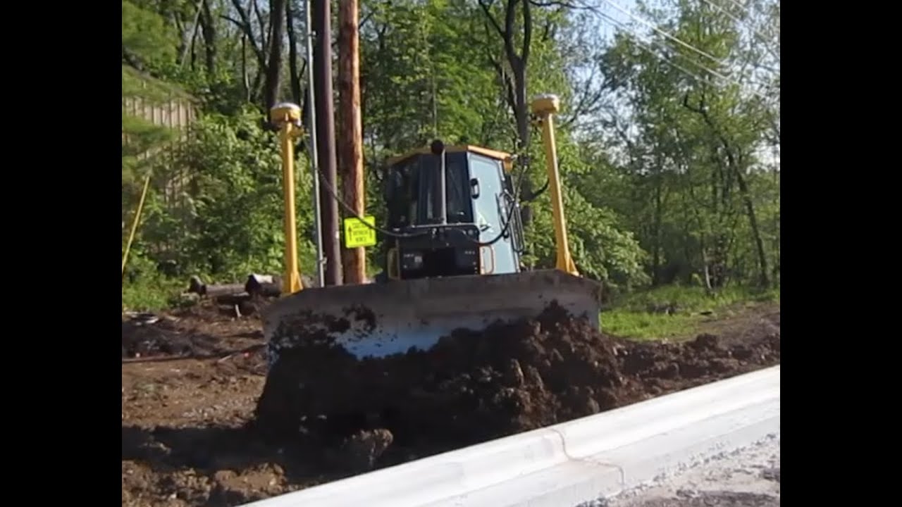 Bulldozer and Hoe Artistes Doing Their Thing