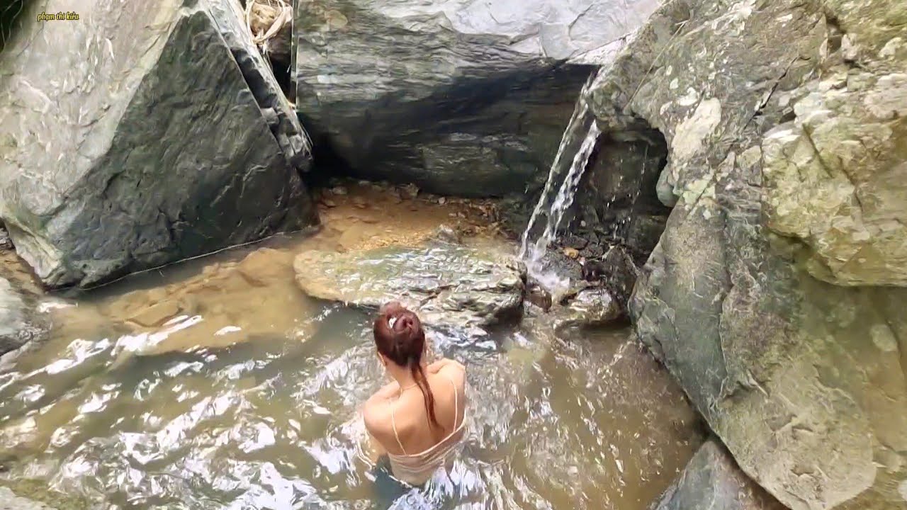 The girl went into the forest to wade in the stream to look for food ...