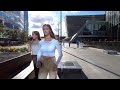 Sunny walk in Moscow city: beautiful people among skyscrapers