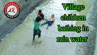 Children Bathing In Rain Water