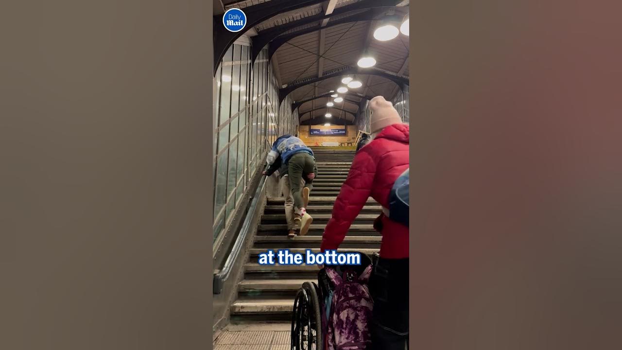 Father carries paralyzed son up 3 flights of stairs after train station elevator breaks down