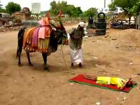 From Aihole in the state of Karnataka. The man is actually playing two instruments at the same time. One provides the drone; the other is the melody.