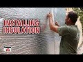 Installing insulation on our diy shop building kits