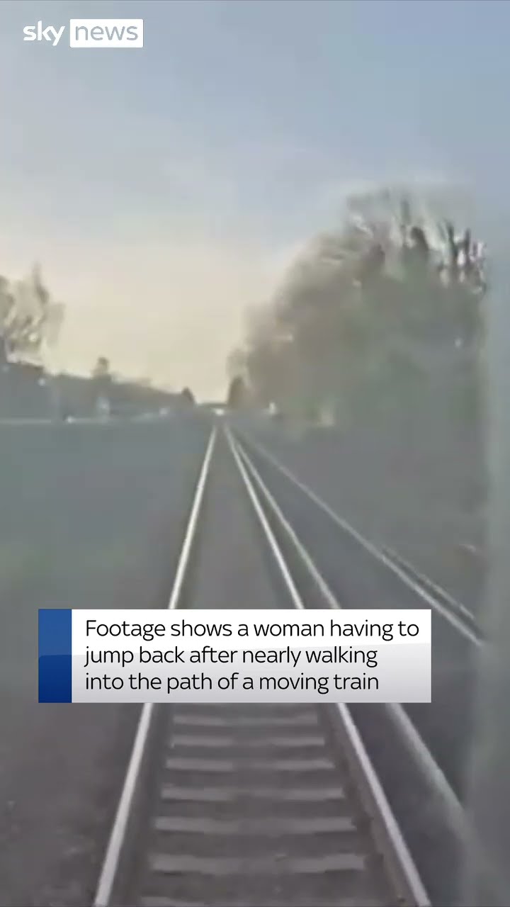 Moment woman is nearly hit by train