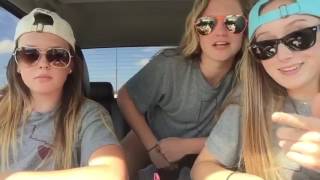 three girls singing in a car