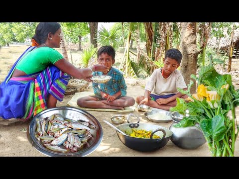 santali tribe mother cooking PUMPKIN LEAVES curry with small fish for her sons