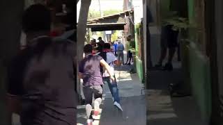 Guy Falls onto the Sidewalk While Racing with His Friend