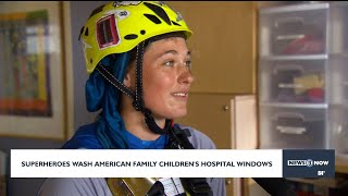 Superheroes wash American Family's children's hospital windows