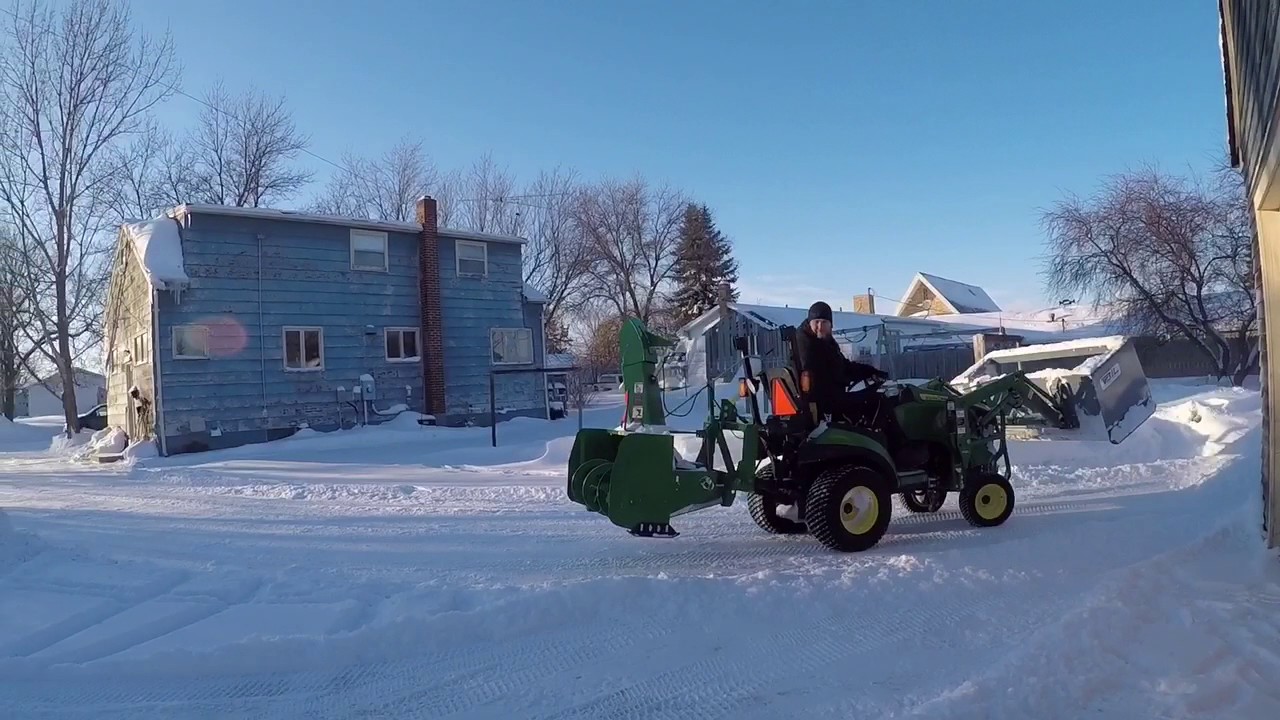 John Deere 1026r pushing light snow with snow pusher YouTube
