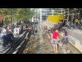 Kids playing in water and giants in the park.