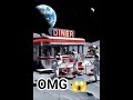 the DINER sign is gently flashing, one astronauts is waving, the other astronauts are playiing cards