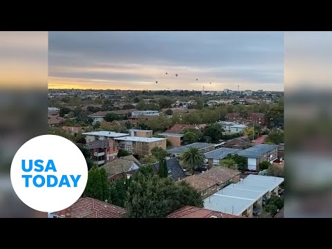 Hot air balloon ride goes sideways, riders nearly touch rooftops | USA TODAY