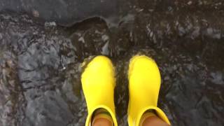 Slow-Mo Yellow Rubber Boots In Rain Waterfall