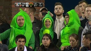 Three fans enjoy the game in pea pod costumes