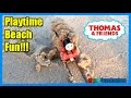 Ryan plays with thomas and friends on the sand