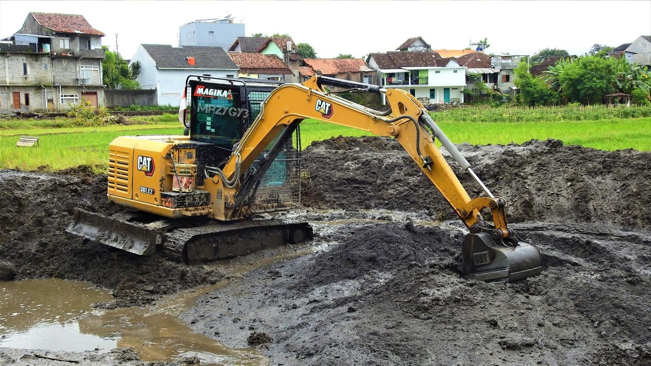 CAT 307 E2 Mini Excavator Digging Deepening A Fish Pond - YouTube