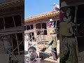 Lifting process of red tiles on villa roof