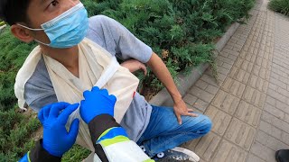 Scooter traffic accident, bandaging the injured arm