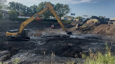 Dredging a pond with a long reach excavator!! 