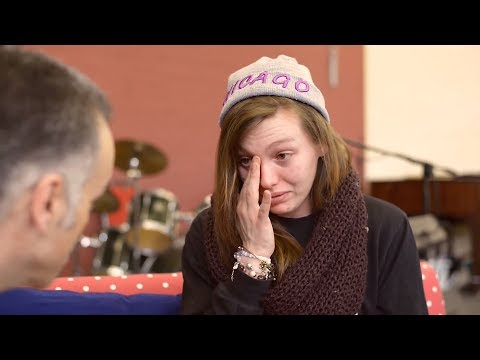 Young lady is moved while Christian prays for her