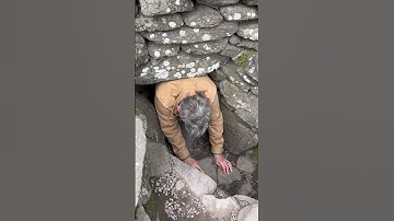Crawled into a 5000 year old ruin in Ireland. A carved stone was at the end of a short tunnel.