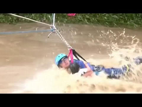 China floods: Child rescued from violent river as flooding continues across country