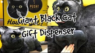 Giant Black Cat Dispenses Gifts From Its Mouth