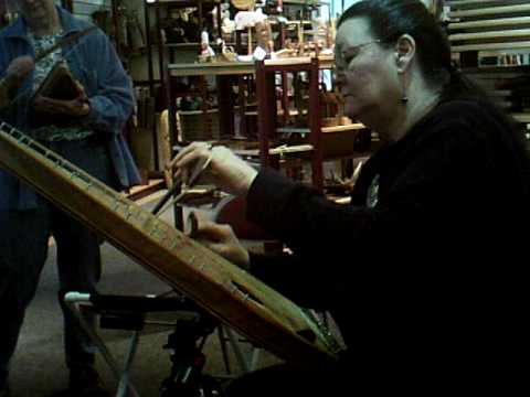 Tish test drives Rick's baritone bowed psaltery.