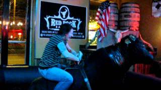 Cathy and Mandy ride a bull